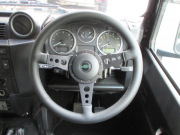 ランドローバー ディフェンダー 110 2.2Tdci パノラミックウィンドウカスタム 新品ブラックWolfstyleスチールホイール＆新品タイヤ 10人乗り Nox/Pm適合 3ナンバー シュノーケル LEDレンズ チェッカープレート 前後ランプガード Fレカロシート モトリタステアリング 並行輸入車 右ハンドル 記録簿付の中古車
